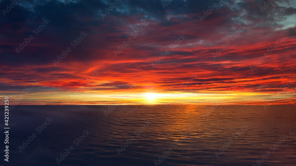 Colorful sunset sky over tranquil sea surface 