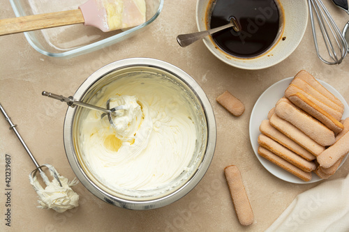 Mixing, whipping cream for cake. Cooking tiramisu cake with sponge fingers cookies. Step by step recipe.