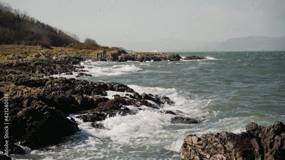 Waves crashing on rocky shore, wide angle, slow motion Waves crashing on rocky shore, wide angle, slow motion