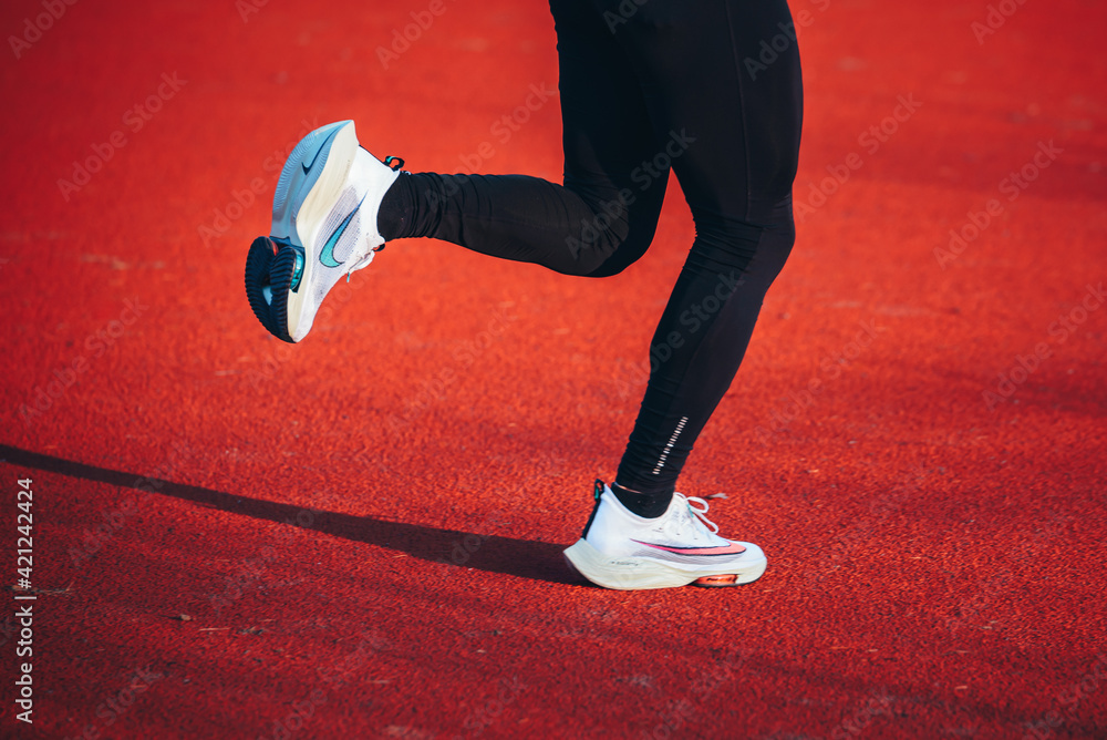 TOKYO, JAPAN, MARCH 18. 2021: Nike running shoes ALPHAFLY NEXT%.  Controversial athletics shoe on legs of professional athlete running on the  road. Official white shoe for Tokyo Olympics 2020 marathon Stock-foto |  Adobe Stock