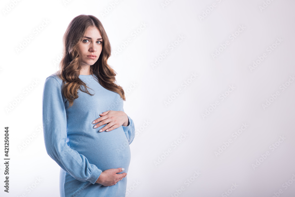 Portrait of a pregnant girl in the studio on a white background with copyspace Portrait of a pregnant girl in the studio on a white background with copyspace