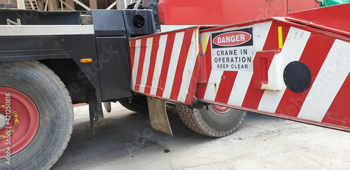 Danger Crane in Operation sign on crane outrigger