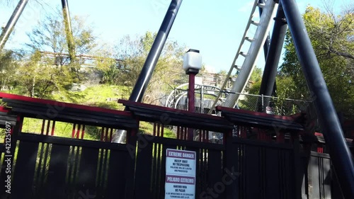 Full Throttle roller coaster at Six Flags Magic Mountain in California. A train travelling down an inversion on a sunny day. photo