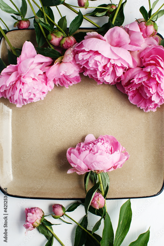 Simple flat lay flower frame of pink peonies