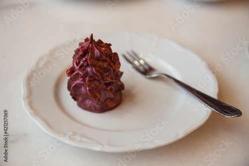 purple dessert on white porcelain plate and cup of coffee