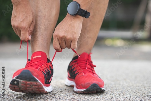 Close up of sportsman tying shoelace.Get ready to start exercising.healthy lifestyle concept.