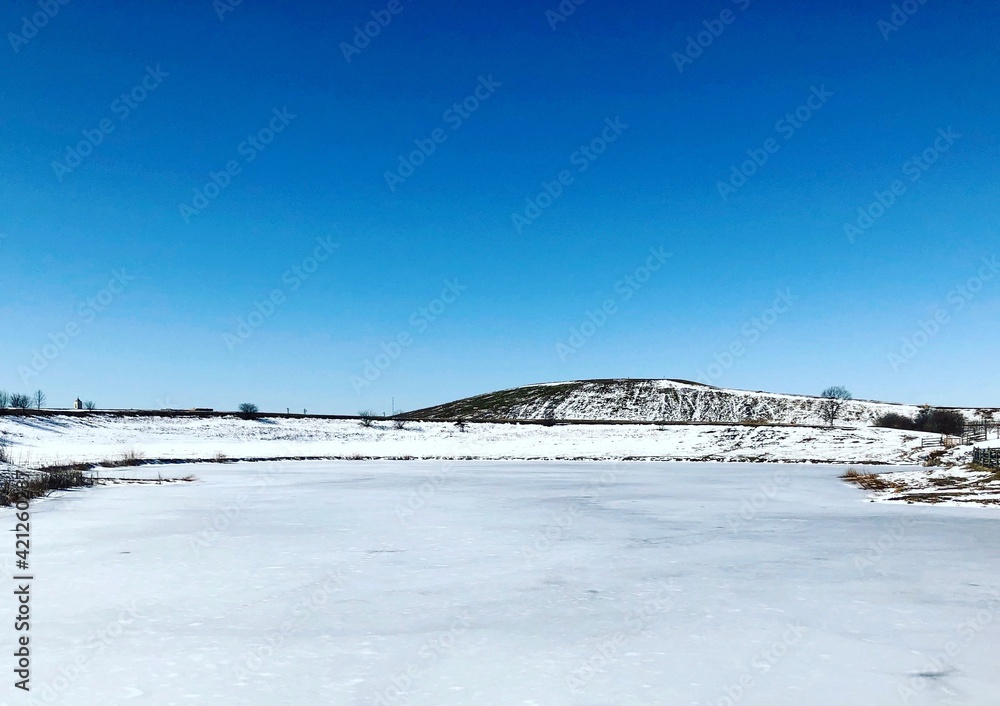 The frozen and snowy landscape in the country.