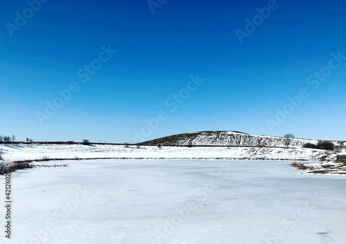 Fototapeta Naklejka Na Ścianę i Meble -  The frozen and snowy landscape in the country.