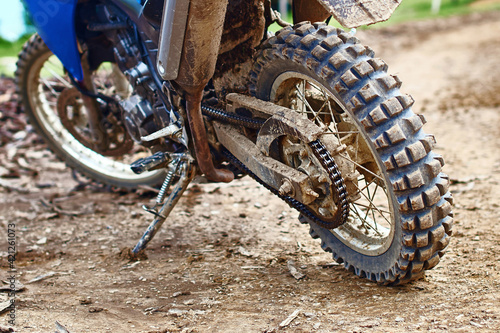 Offroad mountain motorcycle or bike taking part in motocros competition parked on dirty terrain road