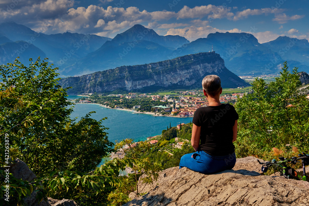 Fototapeta premium Panoramic view on Lake Garda from the Busatte-Tempesta trail near Nago-Torbole with the iron staircase, Torbole town surrounded by mountains in the summer time,Italy
