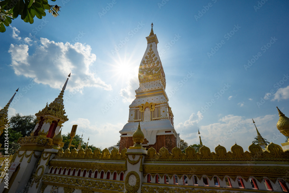 Naklejka premium The Pagoda of Wat Phra That Panom temple in Nakhon Phanom, Thailand in cloudy blue sky day with sunlight
