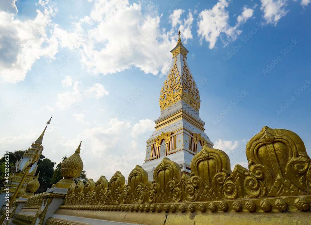 Naklejka premium The Pagoda of Wat Phra That Panom temple in Nakhon Phanom, Thailand in cloudy blue sky day with sunlight