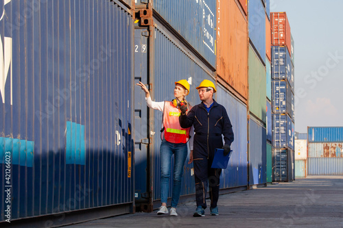 working engineer in the construction container yard. worker and supervisor checking containers data. Container Shipping Logistics Engineering concept