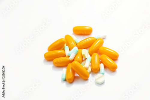 orange pills on white background