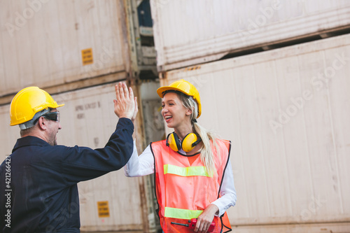 worker giving high five to his friend colleague. Workers hands touching and clapping for sucessfully. Container Shipping Logistics Engineering concept photo