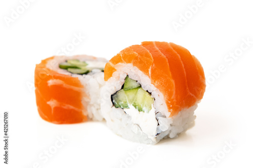 Salmon sushi maki rolls with avocado and cucumber filling, isolated on white background
