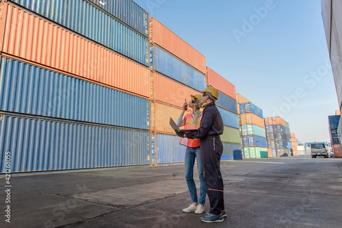 working engineer in the construction container yard. worker and supervisor checking containers data. Container Shipping Logistics Engineering concept