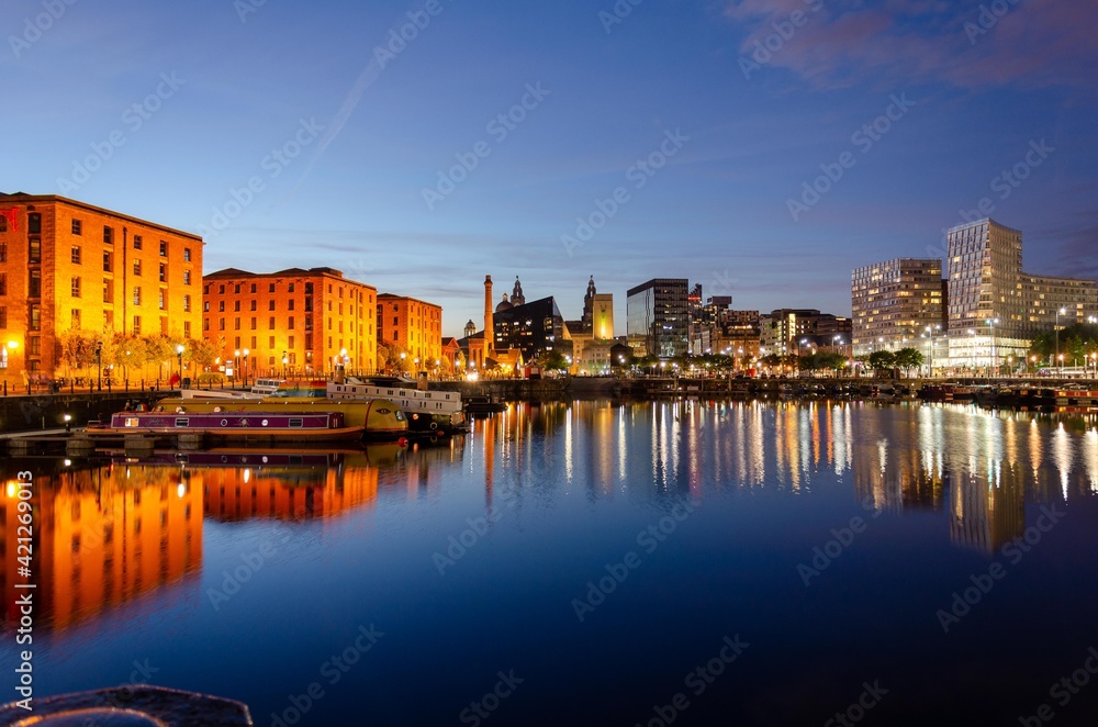 Liverpools Albert Dock in the evening with its buiding reflecting in to the docks still water