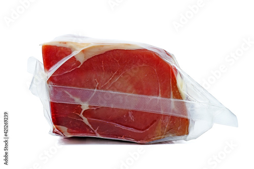 Piece of cured ham in vacuum plastic package isolated on the white background photo