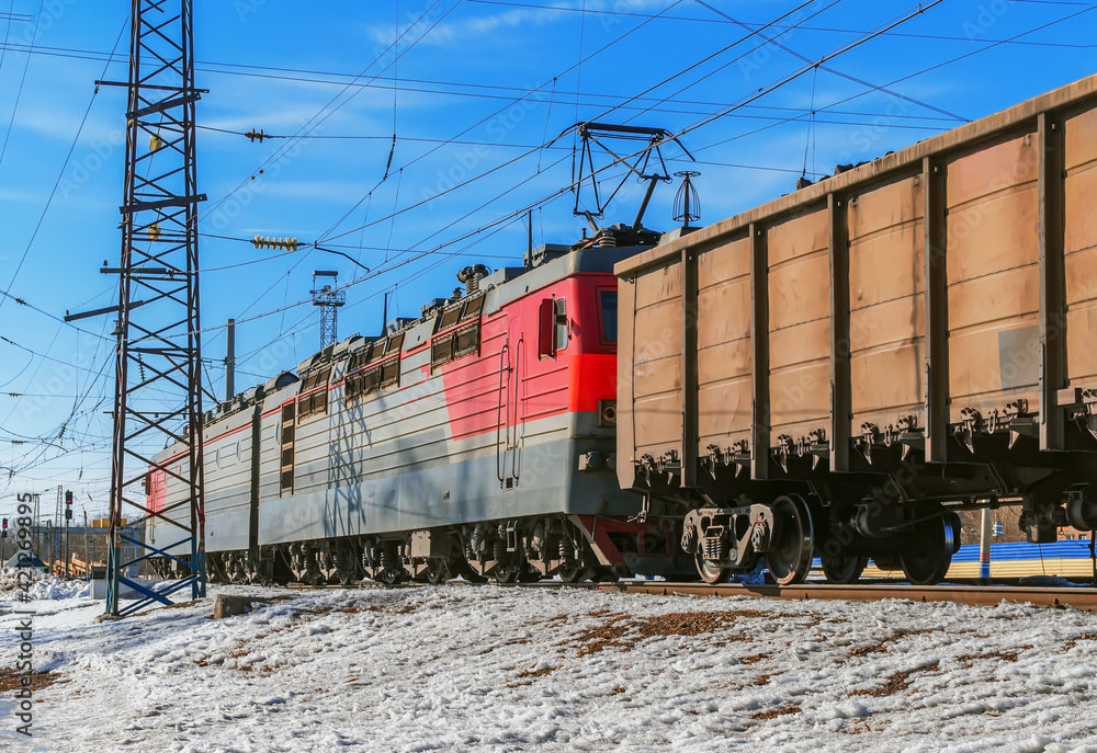 Electric locomotive is pulling a cargo train at one of the marshalling yard of Trans-Siberian Railway. Electric locomotive is pulling a cargo train at one of the marshalling yard of Trans-Siberian Railway.