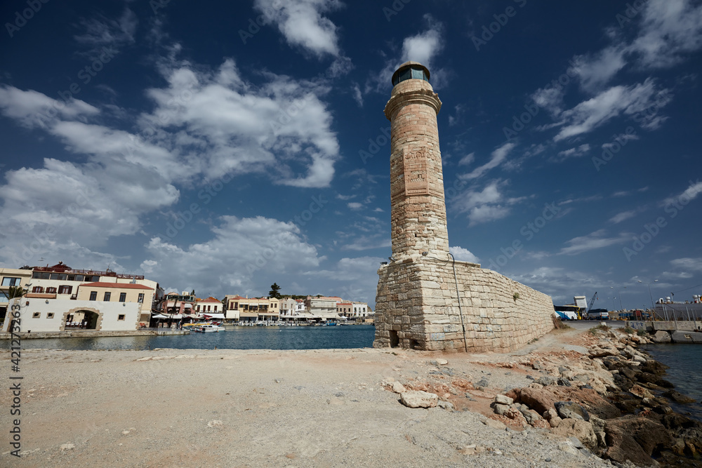 Venetian lighthouse on a background of blue sky with clouds Rethymno Crete Greece