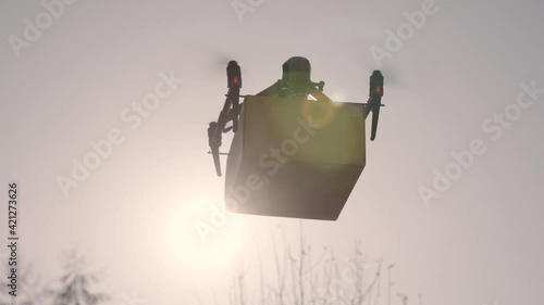 big delivery drone with package attached against the sunlight