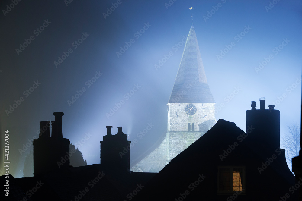 St. Bartholemew's church and roof tops in fog