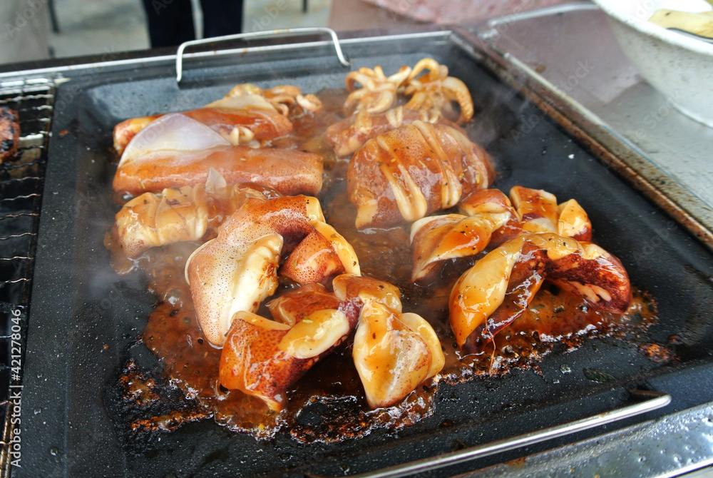 The squid is sliced and marinated with spices. Grilled on a frying pan.