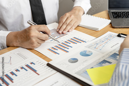 Finance staff is preparing company financial documents, data sheets in the form of charts as the company's financial, sales and expenditures to be brought into the meeting. Financial concept.