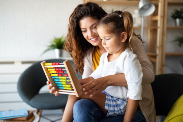 Mother and little cute girl, kid playing with abacus, early education