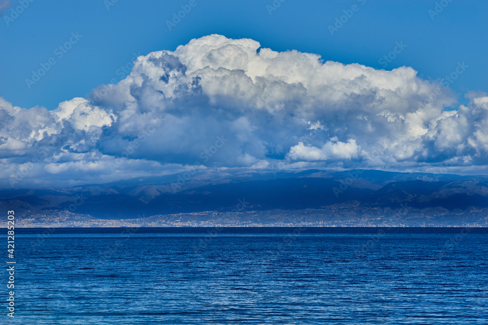 threatening clouds gather on the coast of Calabria and on the calm blue sea