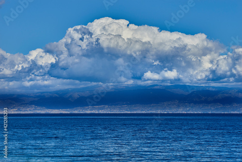 threatening clouds gather on the coast of Calabria and on the calm blue sea