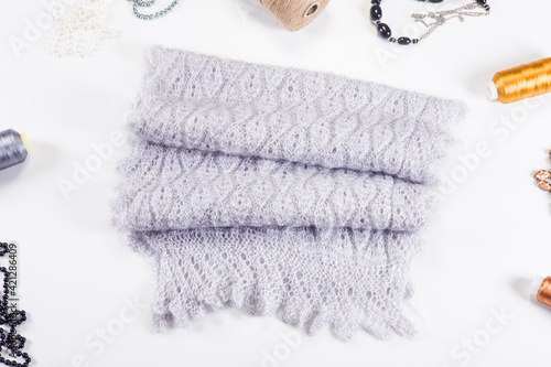 top view closeup on folded handmade grey woolen scarf with knitted pattern