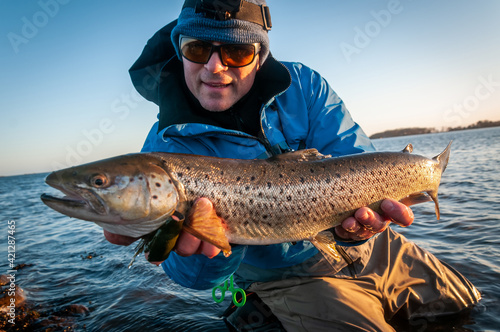 Angler with spring brown sea trout
