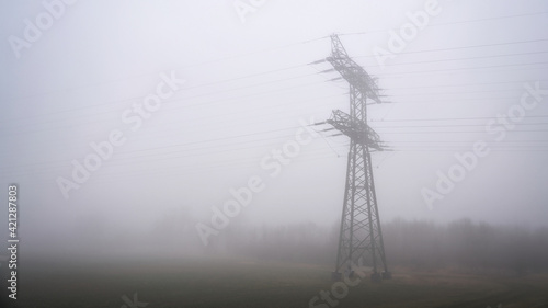 Power pole on a field near Magdeburg in Germany in fog