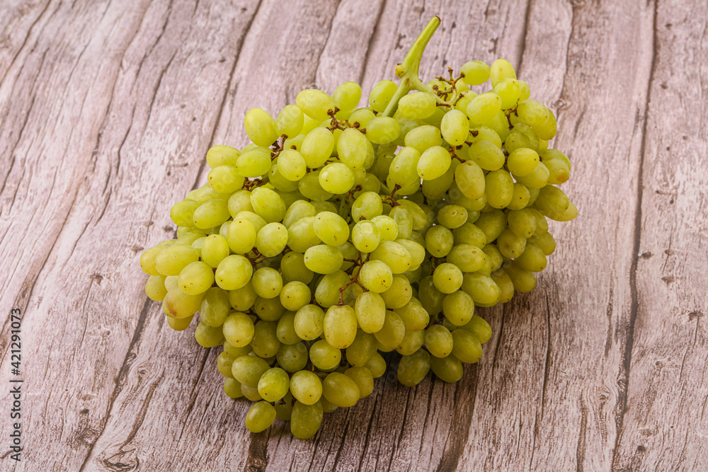 Green grape branch over background Green grape branch over background