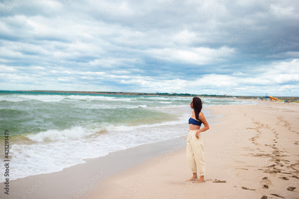 Young happy woman on the beach