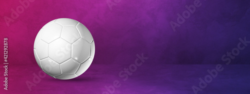 Fototapeta Naklejka Na Ścianę i Meble -  White soccer ball on a purple studio banner