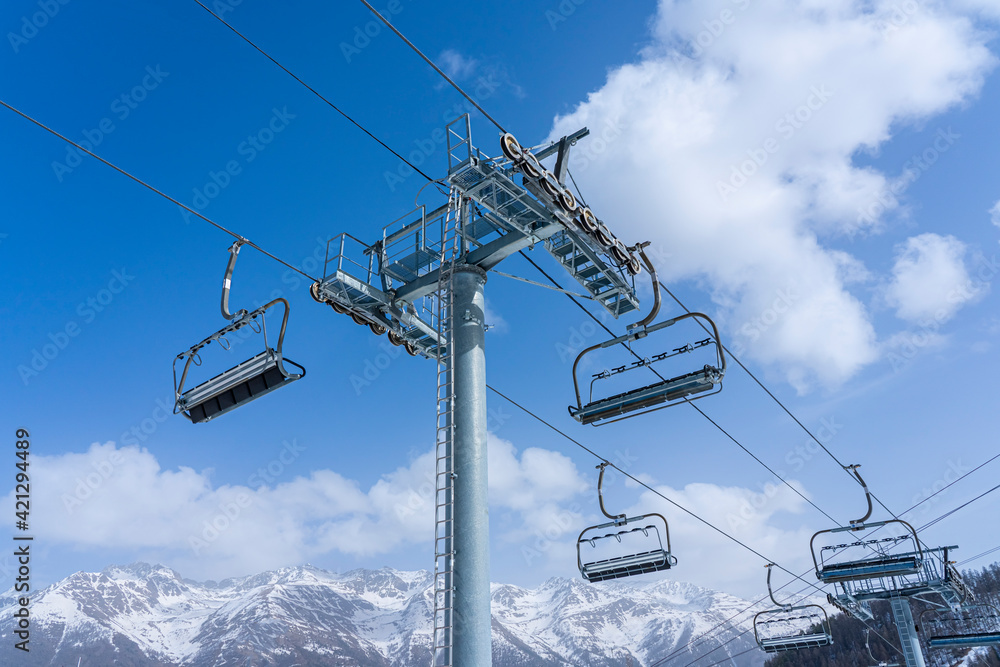  Empty ski slopes and ski lifts in ski resort. During the winter holidays 2021 lifts are closed for skiing for adults due to the coronavirus pandemic.