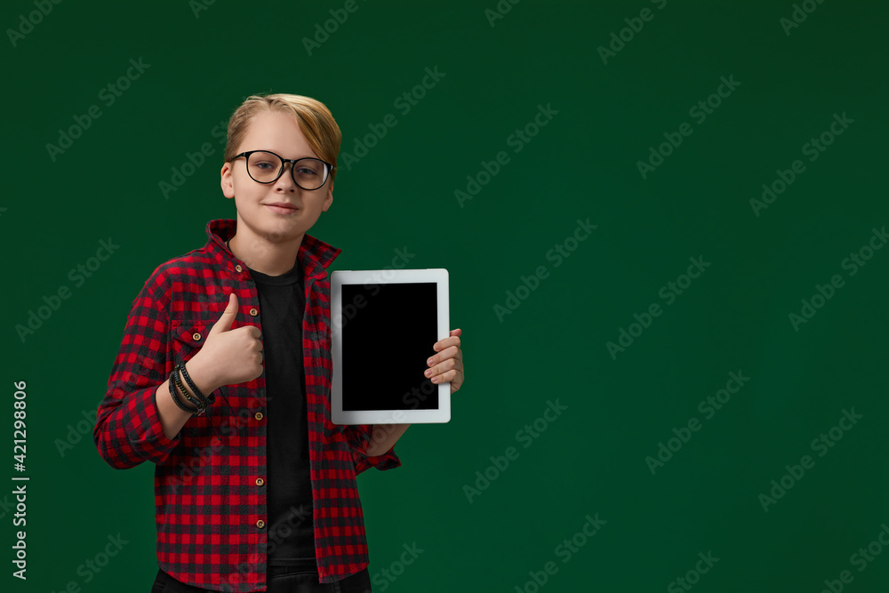 child boy in red checkered shirt shows empty tablet child boy in red checkered shirt shows empty tablet