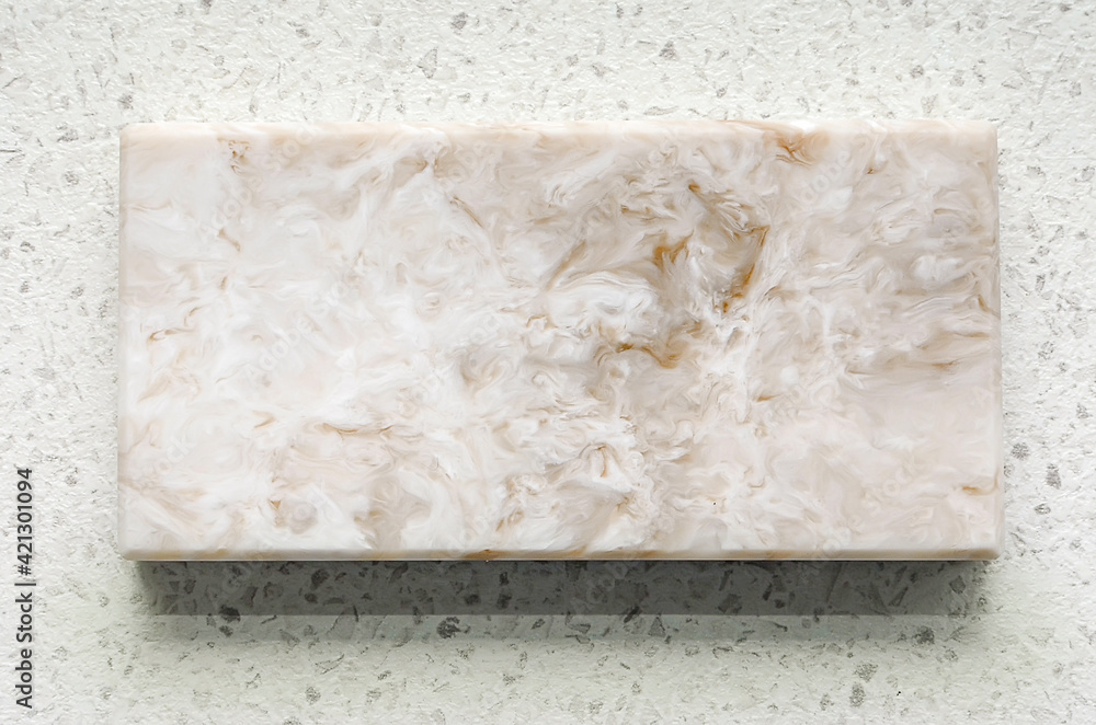 A sample of an artificial stone with a marble texture. Close-up, abstract pattern.