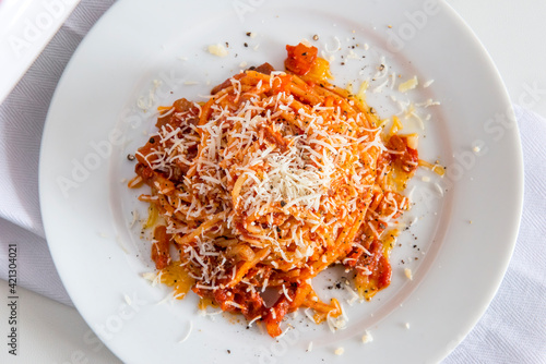 Plate of spaghetti with tomato and bacon and pecorino cheese