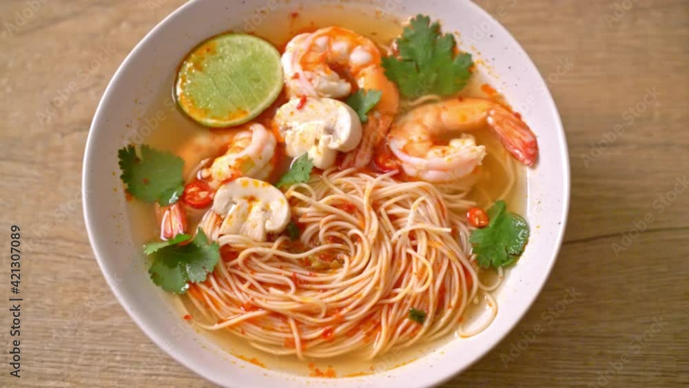 noodles with spicy soup and shrimps in white bowl (Tom Yum Kung) - Asian food style noodles with spicy soup and shrimps in white bowl (Tom Yum Kung) - Asian food style