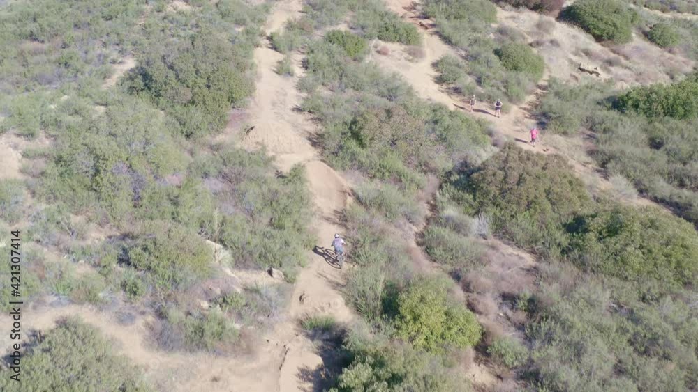 Offroad mountain bikers jumping dirt ramps by drone Offroad mountain bikers jumping dirt ramps by drone
