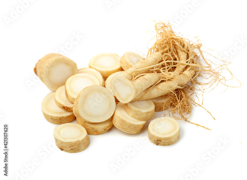 fresh ginseng root slices on white background