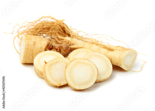 fresh ginseng root slices on white background