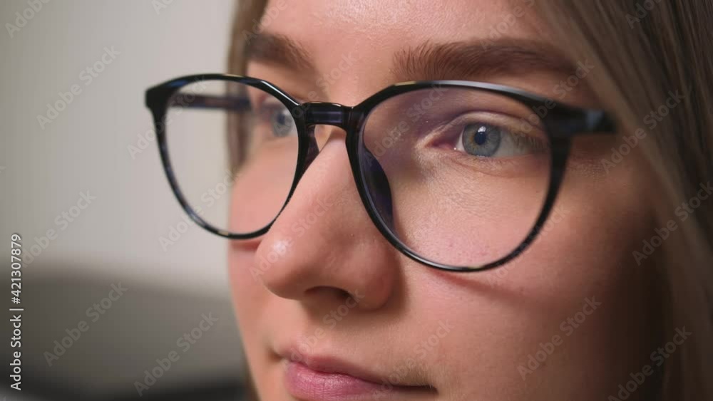 Closeup of Woman Face in glasses, woman has beautiful blue Eyes. Natural Beauty. Gorgeous woman with long Eyelashes and Attractive Appearance. Slow motion. Closeup of Woman Face in glasses, woman has beautiful blue Eyes. Natural Beauty. Gorgeous woman with long Eyelashes and Attractive Appearance. Slow motion.