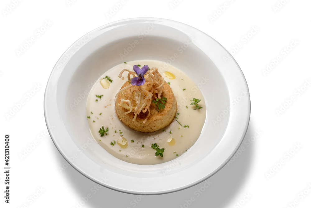 savory flan of leeks in cream cheese and olive oil, in white plate isolated on white, top view savory flan of leeks in cream cheese and olive oil, in white plate isolated on white, top view