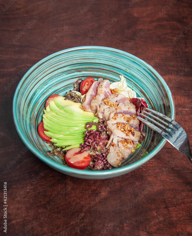 Fresh fry meat with vegetables and green avocado Fresh fry meat with vegetables and green avocado