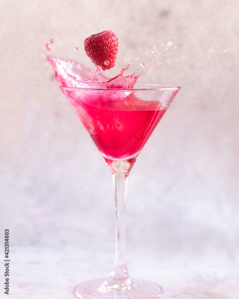 Pink Cocktail drink with a Raspberry Pink Cocktail drink with a Raspberry